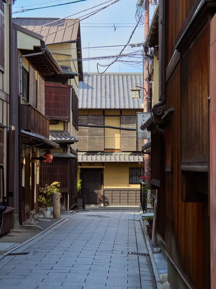 Traditional wooden townhouses lining a narrow alley in Gion, Kyoto